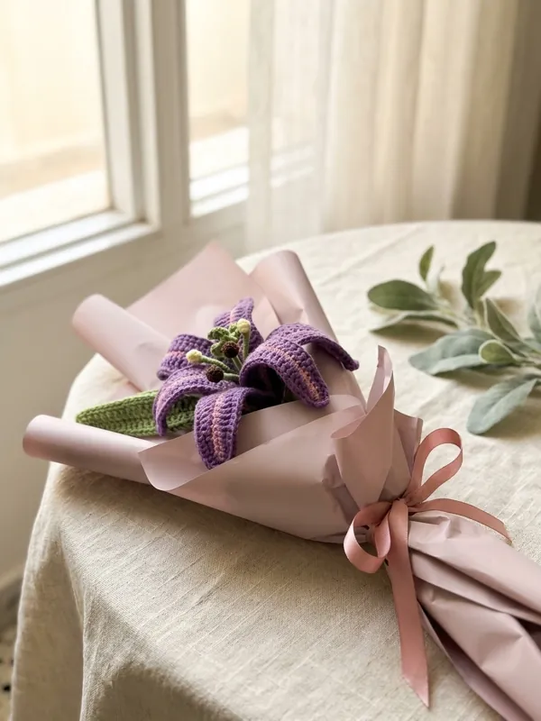 Crocheted lilies in paper wrap, ready to be given as a bouquet